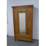 Mahogany wardrobe, projecting cornice over a mirrored door with internal hanging rail, the base with