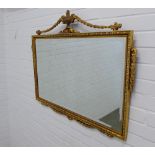 Gilt framed wall mirror with classical urn surmount. 77 x 97cm.