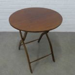 A late 19th / early 20th century mahogany Campaign / coaching table, circular top with brass hinges,
