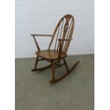 An Ercol elm and beech rocking chair with swan splat back. 92 x 65cm