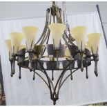 Chelsom bronze patinated chandelier, circular frame with twelve sconce arms with fluted glass