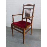 An Arts & Crafts oak open armchair with red upholstered seat, 106 x 58 x 47cm.