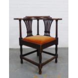 A mahogany corner chair with double pierced splat back, upholstered slip in seat, raised on baluster