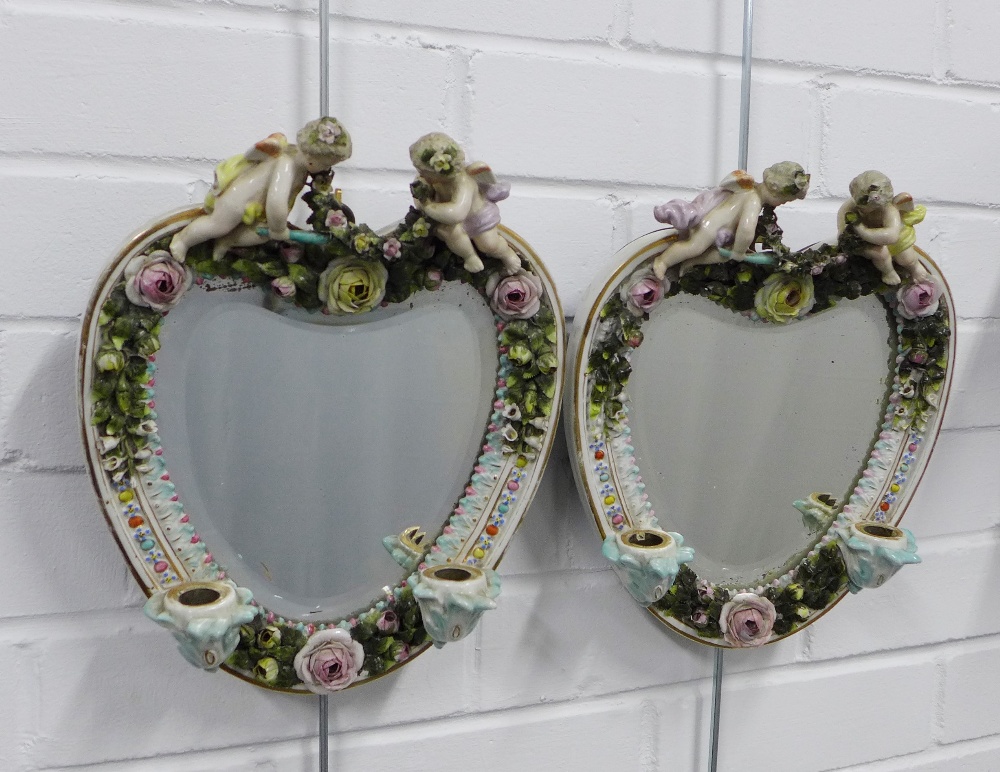 Pair of continental porcelain wall mirrors / candle sconces, heart shaped with cherubs and floral