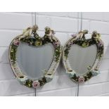 Pair of continental porcelain wall mirrors / candle sconces, heart shaped with cherubs and floral