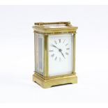 Brass and glass panelled carriage clock, roman numerals, with key, 14cm high including handle