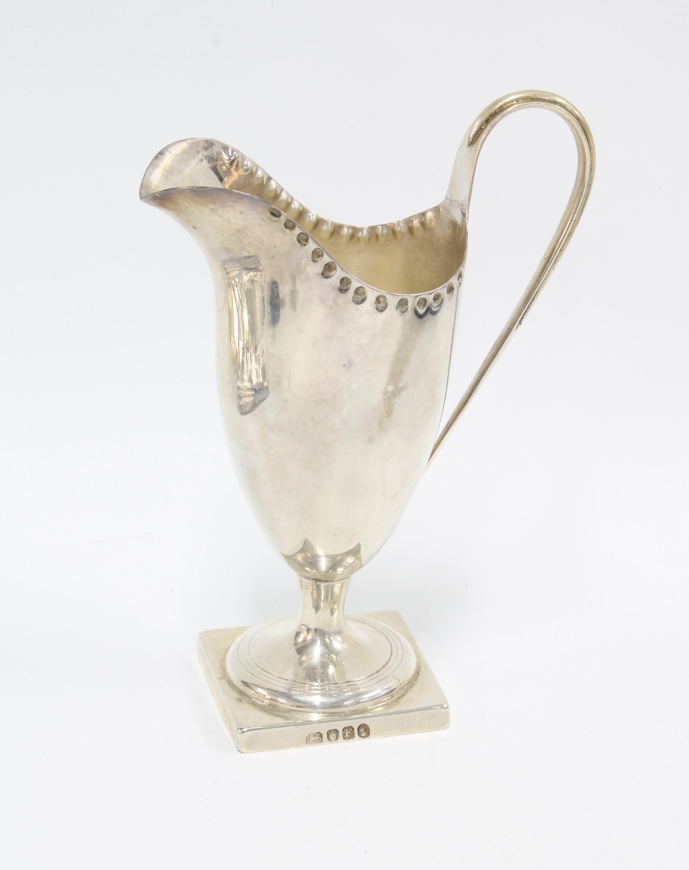Georgian silver cream jug, London 1801, helmet form with punched ri and square footrim, 14cm