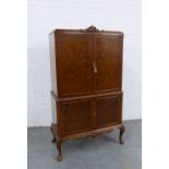 Queen Anne style walnut drinks cabinet with four doors, glass shelved interior to top, raised on