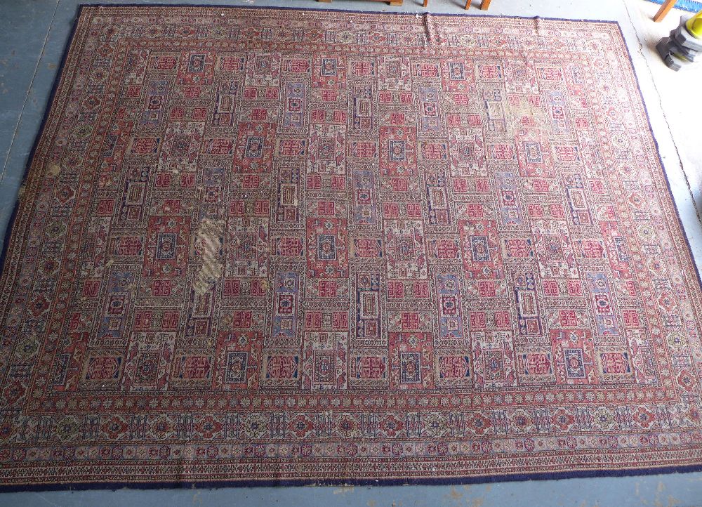 Large Eastern carpet, pink field with allover pattern of square panels within flowerhead borders,