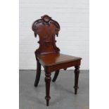 Mahogany hall chair with carved shield back, solid seat and fluted legs, 89 x 45 x 37cm.
