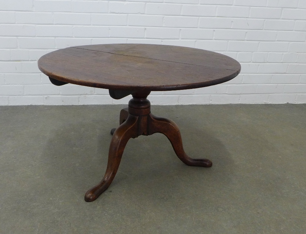 19th century tilt top table, circular top (split) on tripod legs and pad feet, 49 x 82 x 80cm.