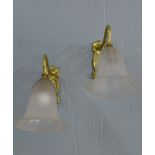 A pair of Art Nouveau style brass wall lights with opaque glass shades (2)