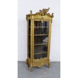 Gilt wood glazed cabinet, Italianate in style, with rococo surmount and mouldings, front door is