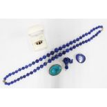 Two white metal mounted lapis brooches and a doublet strand of beads with 9ct gold clasp together