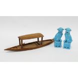 A pair of Chinese turquoise glazed Temple Lions / Dogs of Fo and a wooden boat with paddle, (3)