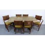 An Ercol oak dining table and set of six Jacobean style chairs with slip in seats. 72 x 153 x