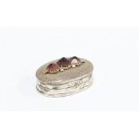 Small silver pill box, the hinged lid with three garnets, stamped 925, 3cm