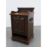 A carved oak purdonium / coal scuttle with brass handles to the side. 68 x 40 x 36cm.