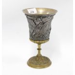 Mixed metal goblet, the flared bowl with classical figures in relief on a knop stem with circular