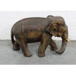 Large carved wooden elephant with light wood tusks simulating ivory, 30 x 50cm