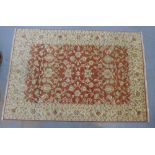 Eastern carpet, beige field with terracotta floral panel, 290 x 194cm.