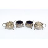 Four piece silver cruet set, Chester 1911, comprising two salts and two mustards, with blue glass