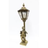 Brass figural table lamp base with a boy standing beneath a lamp post with glass panelled lantern