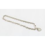 Silver curb link necklace with two heart shaped pendants inscribed 'Tiffany & Co'