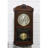 Early 20th century wall clock with silvered dial, key and pendulum, 59 x 30cm