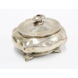 George V silver tea caddy of lobed form, the hinged cover opening to reveal the original silver