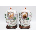 Pair of Chinese famille rose vases with covers on wooden stands, 36cm (2)