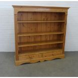 Pine open bookcase with panelled back and two short drawers, 150 x 151 x 36cm.