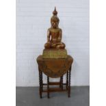Painted giltwood Buddha together with an oak gateleg table (2) ,