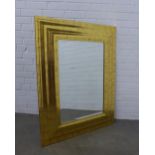 Gilt wood rectangular wall mirror with cushion frame, 84 x 108cm.