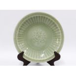 Chinese Ming Dynasty celadon dish, circular with flowers to the centre, approx 27cm diameter.