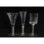 An 18th century enamel twist wine glass and two later air twist stemmed glasses, (3) 18cm