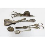 19th century white metal tongs, candle snuffers and grape scissors together with a pierced two