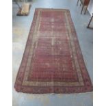 19th century Sarabend runner, red field with boteh, a/f with wear and holes, 400 x 182cm