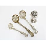 A pair of early 19th century silver sifter spoons together with a smaller example and a white