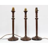 Three mahogany corinthian column table lamps, 43cm (3)