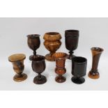 A collection of eight treen goblets and vases, tallest 18cm (8)