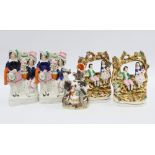 Five staffordshire figures, including a cow with milkmaid spill vase and two pairs, tallest 18cm (5)