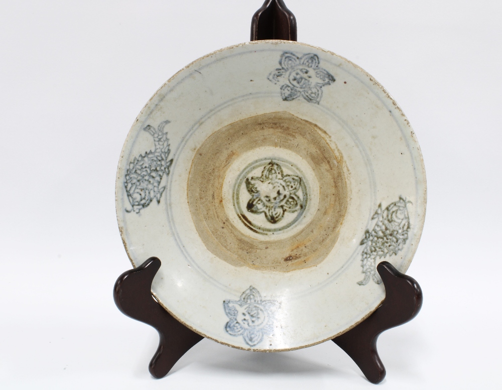 Chinese provincial pottery bowl, greyish glazed body with blue pattern of fish with an unglazed