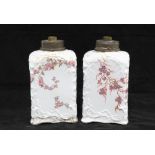 A pair of early 20th century porcelain table lamp bases, white glazed with purple blossoms