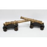 Pair of bronze signalling style canons on wooden bases, 17 x 40cm (2)