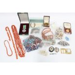 Quantity of vintage costume jewellery contained within a brown leather suitcase to include coral