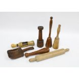 Collection of treen kitchenalia to include a bottle corker, potato masher, oat rolling pin and an