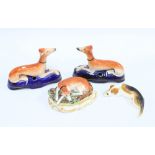 A pair of Victorian Staffordshire greyhound pen holders, 9cm tall, together with another greyhound