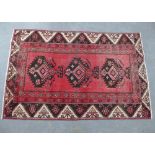 Persian rug, red field with three medallions with serrated edges, 185 x 120