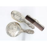 Edwardian silver backed dressing table brush set, Birmingham 1907, comprising a hand mirror, hair